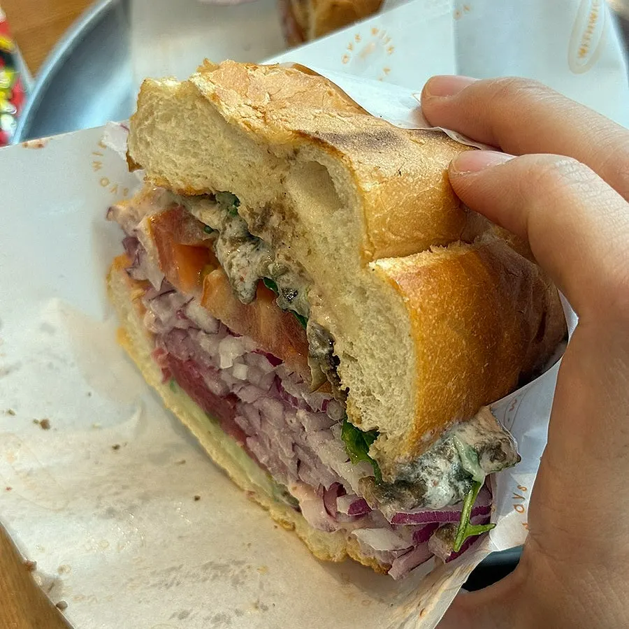 The truffle vegetable sandwich with a bite taken out