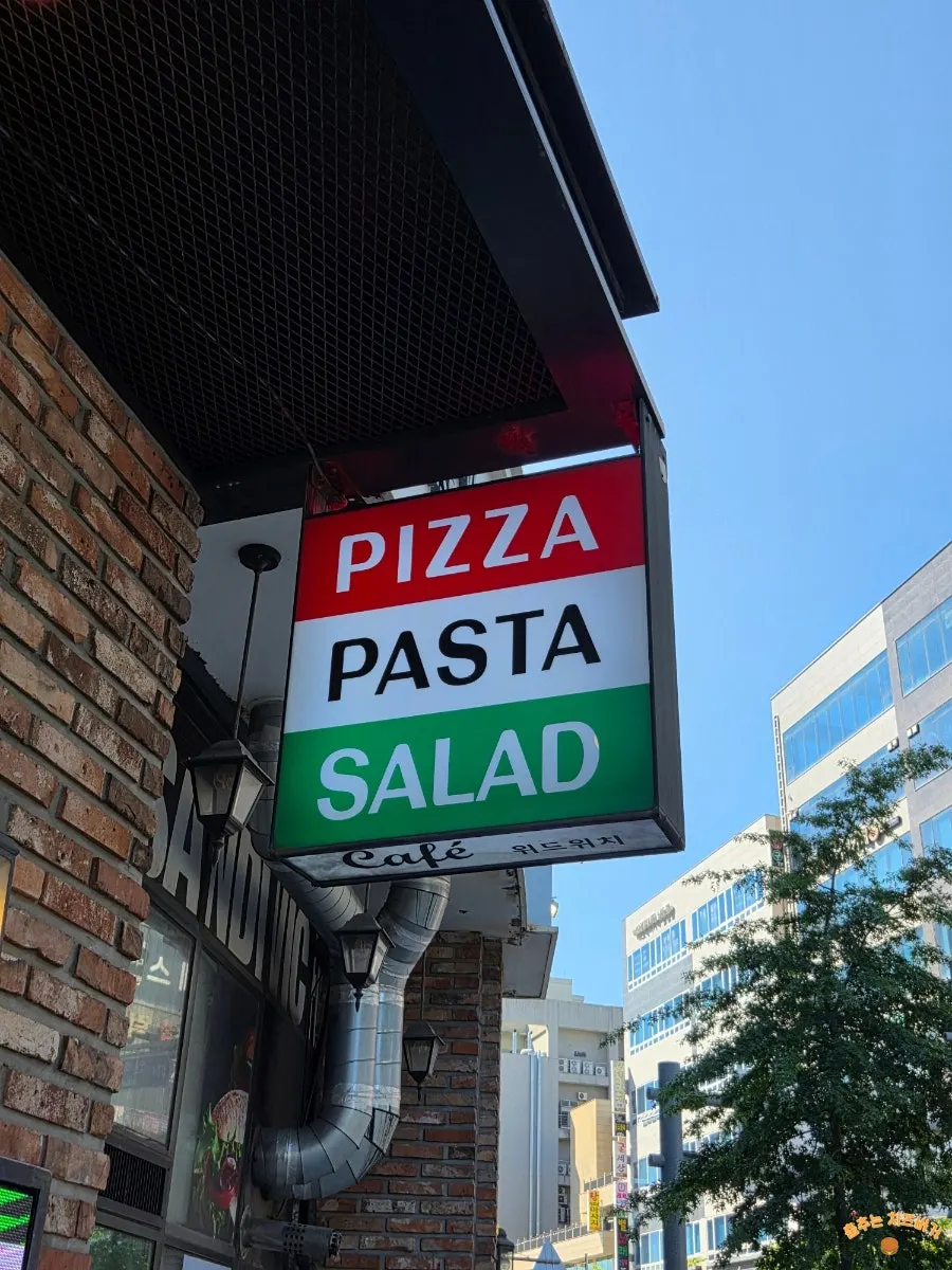 Withwich sign advertising pasta, pizza, and sandwiches