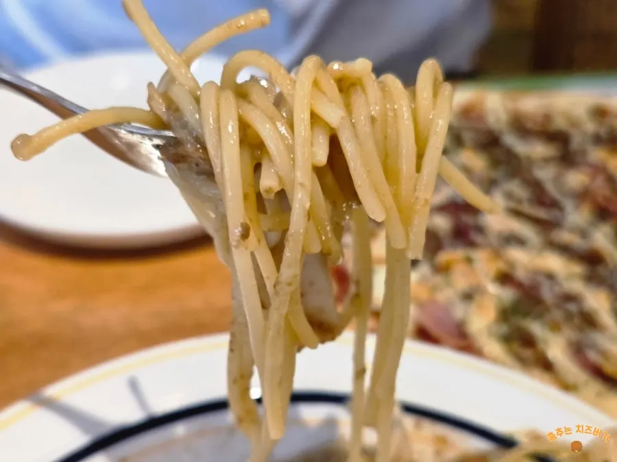 A fork lifting noodles from the truffle pasta