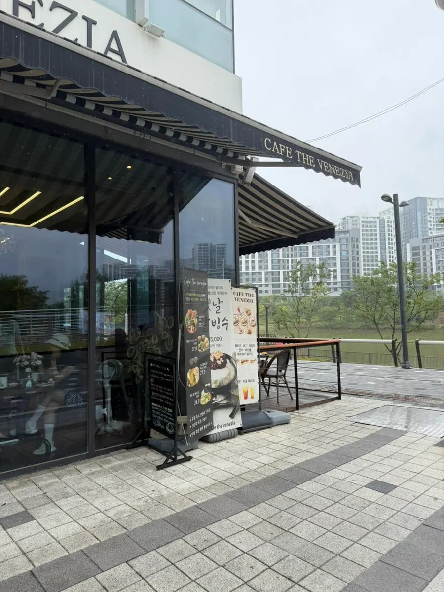 Outdoor terrace seats with lake park view on a rainy day