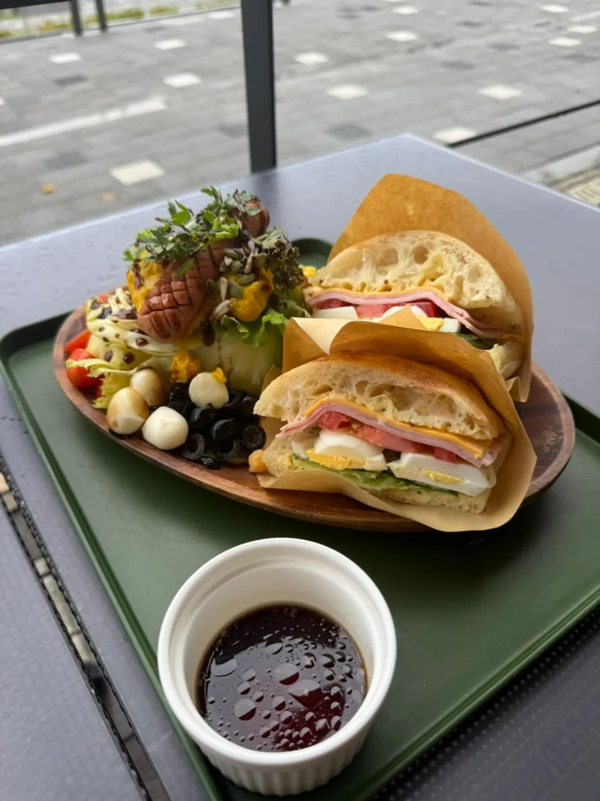 Sandwich, salad, and two Americanos set