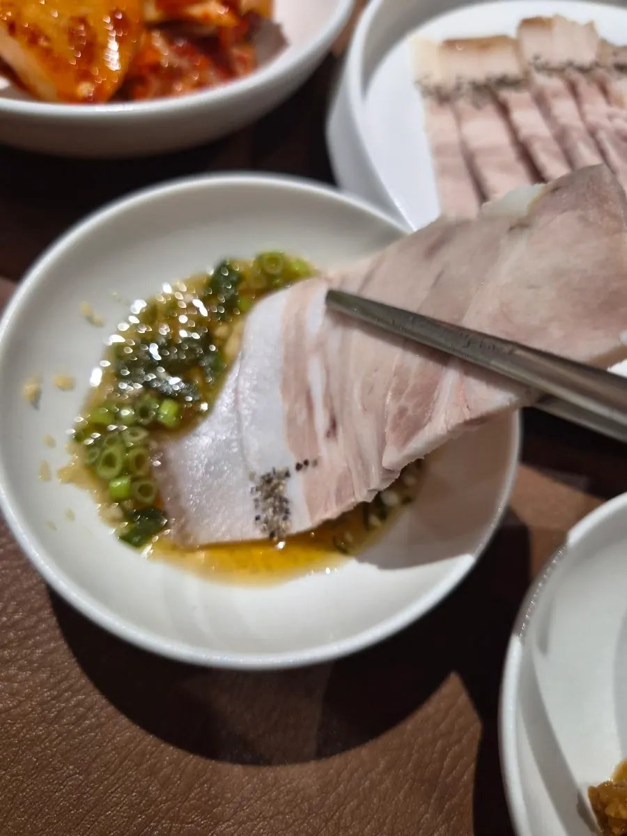 Half plate of cold jeyuk served with dipping sauce