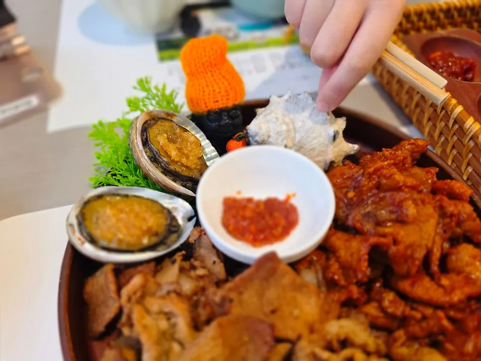 Plate with two buttered grilled abalones