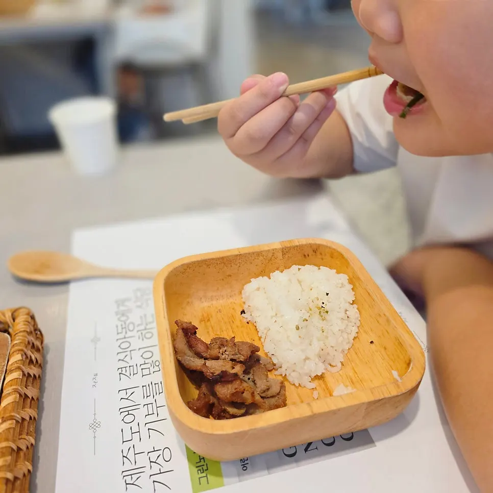 A bowl of kids' meal placed in front of a child