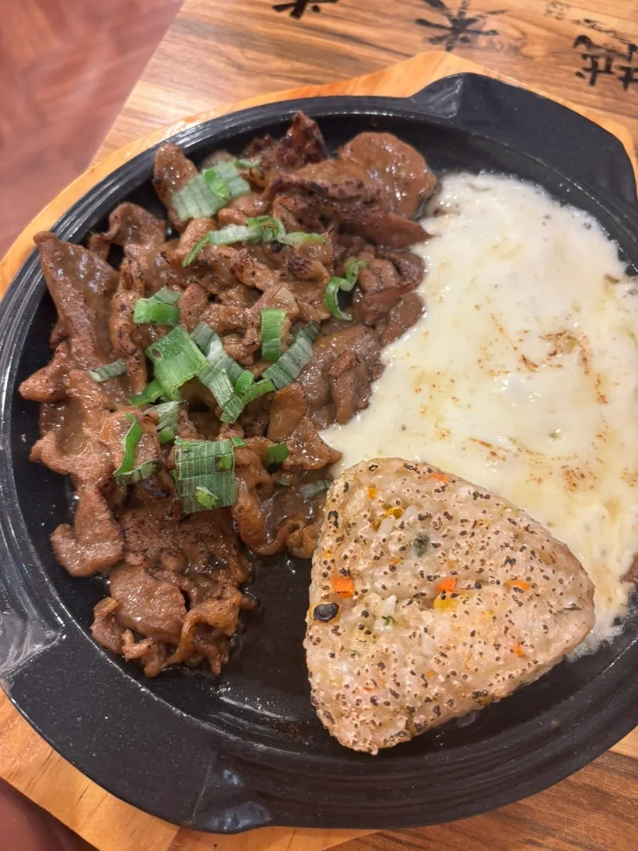 A plate of soy-grilled bulgogi with cheese and grilled rice balls