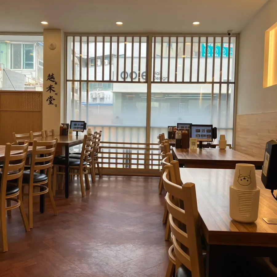 Interior view showing ordering kiosks at each table