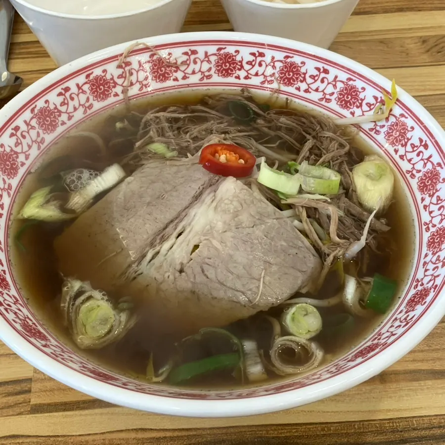 A bowl of beef brisket pho with bean sprouts