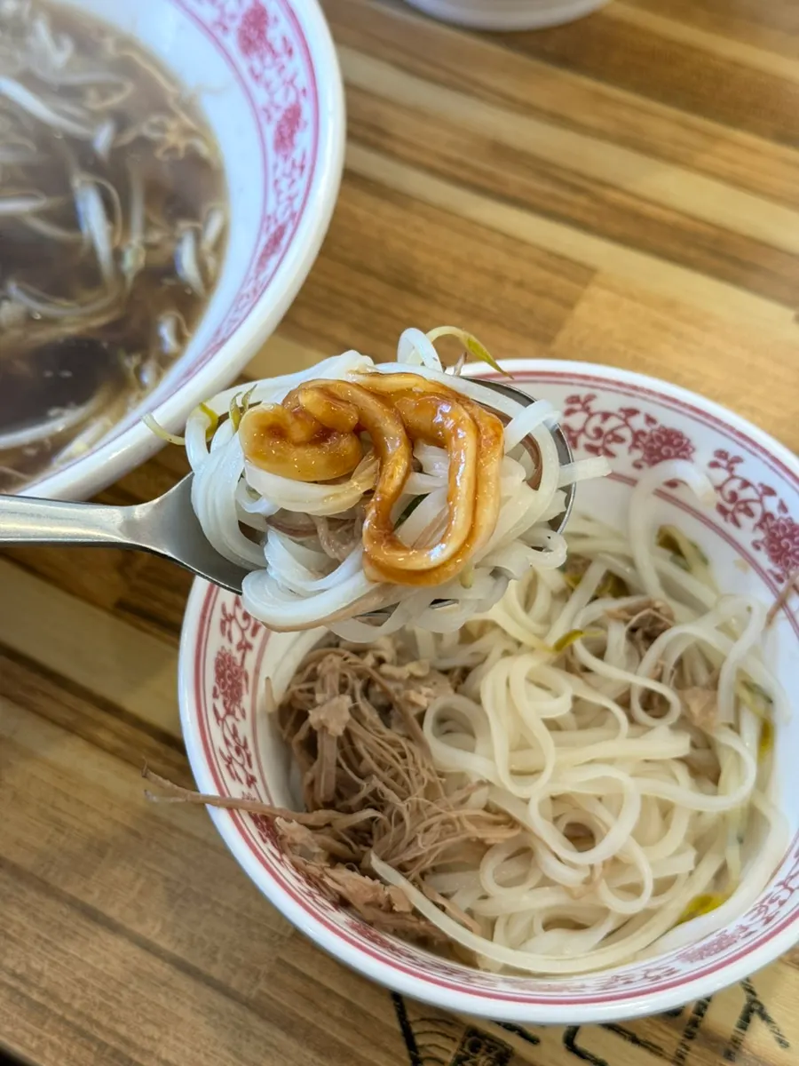 Pho noodles topped with meat