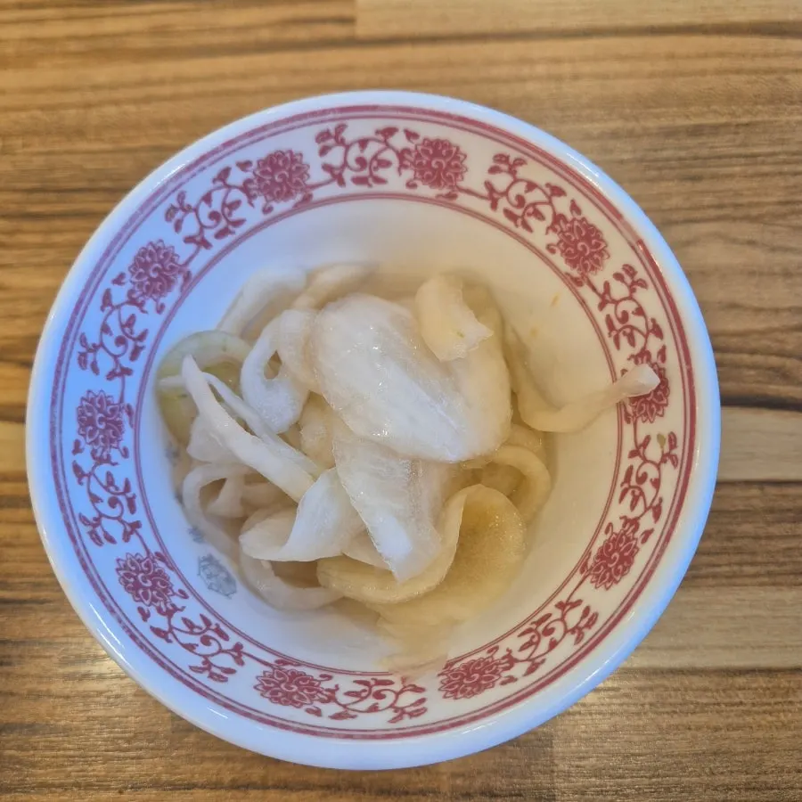 Tangy pickled onions served alongside the pho