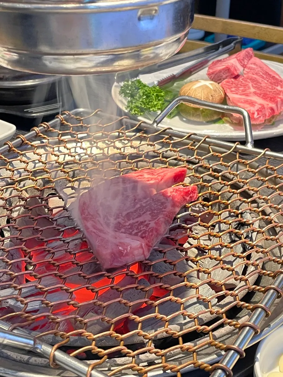 Two-plus grade hanwoo flower ribeye placed on the charcoal grill