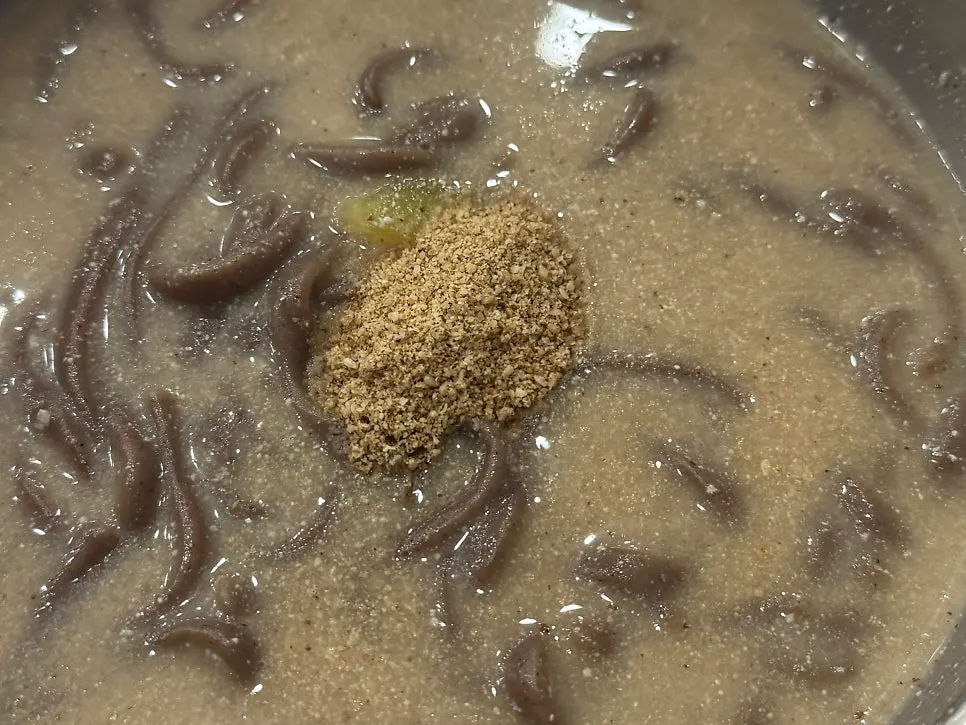 Perilla buckwheat kalguksu topped with a generous mound of perilla powder