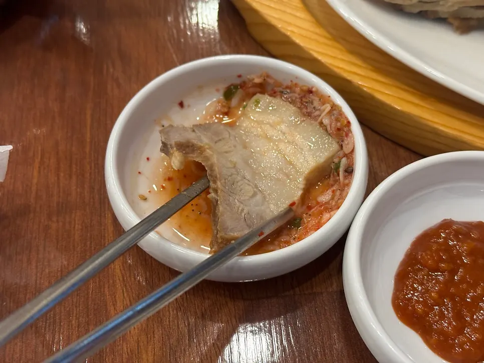Side dish of salted shrimp, red sauce, raw garlic, and peppers