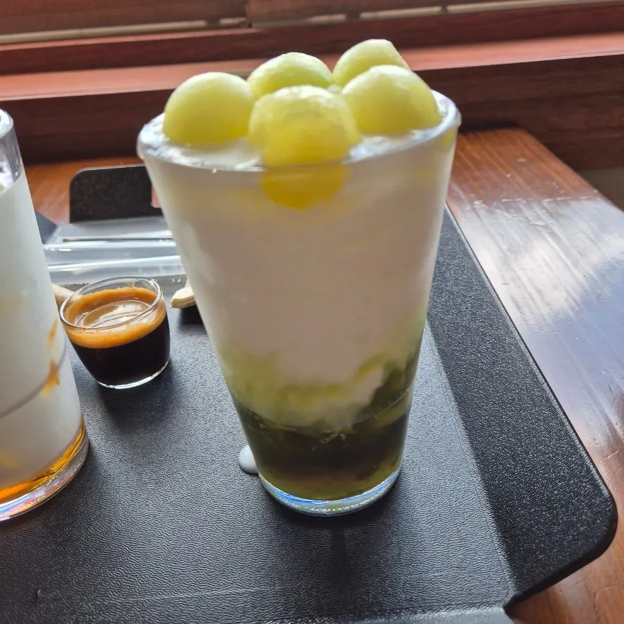 Fresh melon yogurt smoothie topped with melon pieces