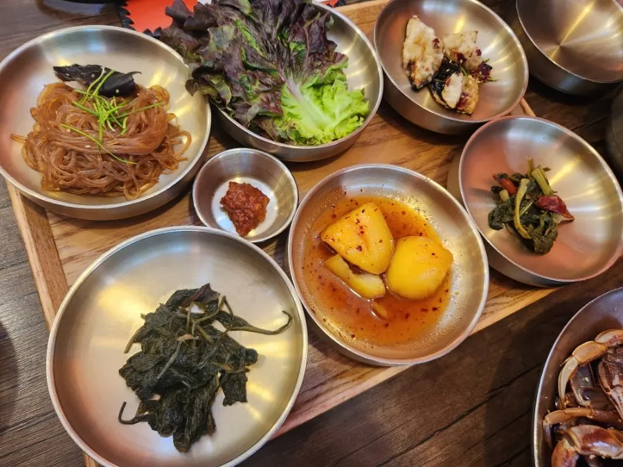 Japchae and side dish plates among the 12 side dishes