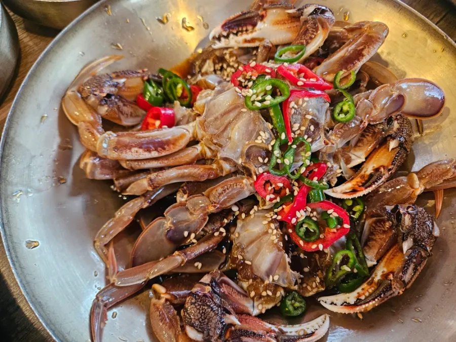 Nine side dishes including japchae, fried eggplant, and doraji salad