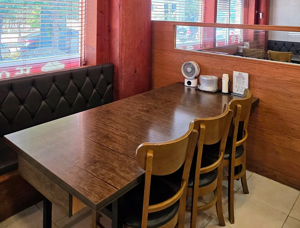Dining hall seating with large, well-spaced tables