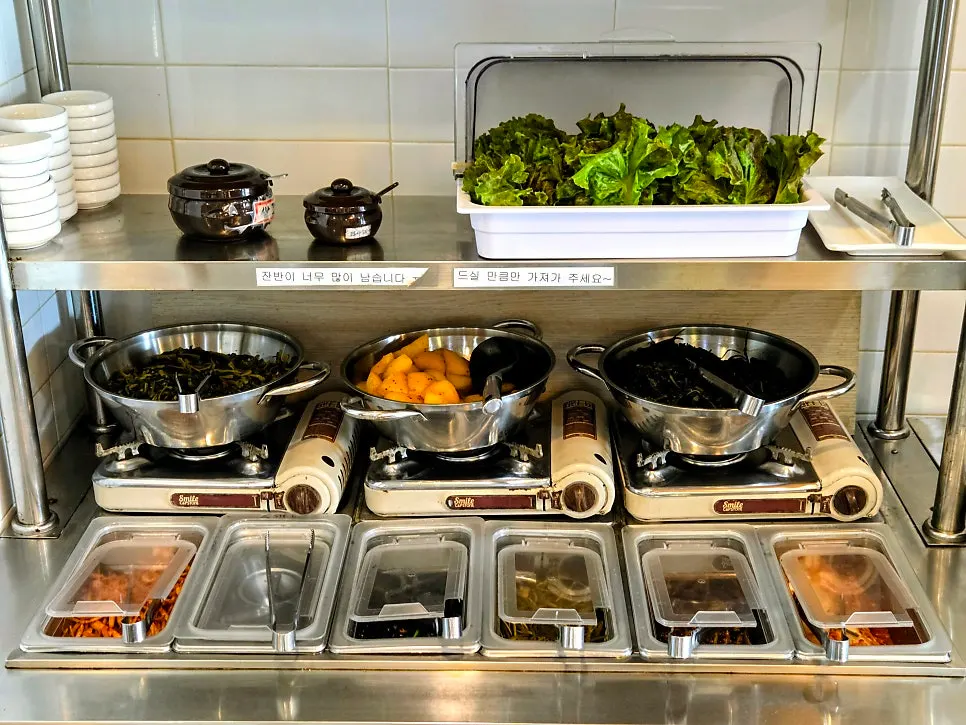 Self-serve bar on one side of the restaurant filled with side dishes