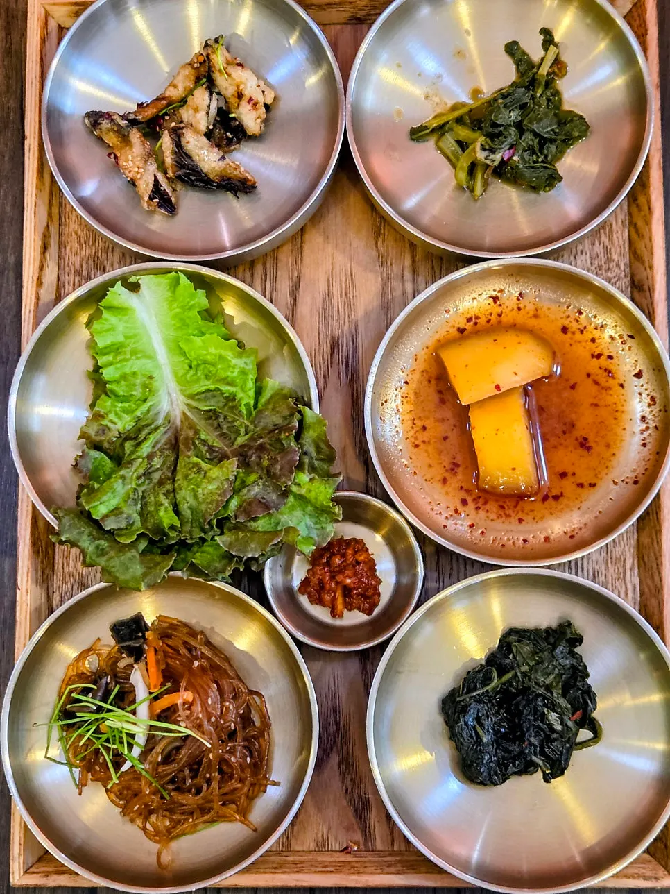 Twelve seasonal side dishes served in small bowls