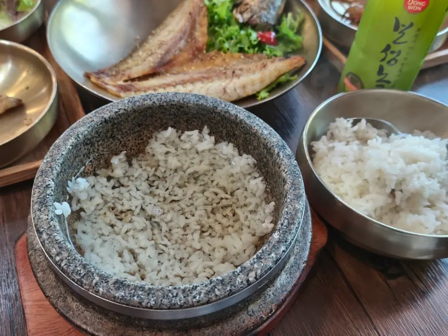 Stone-pot rice scooped into a bowl