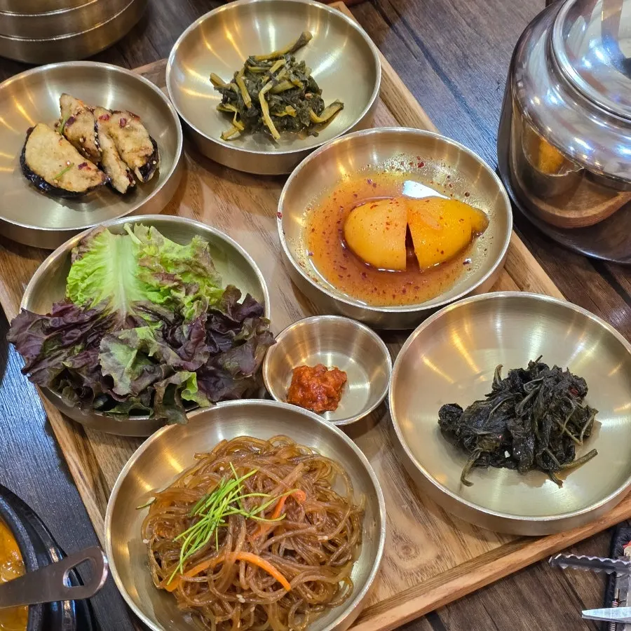 Close-up of braised potatoes and other hanjeongsik side dishes