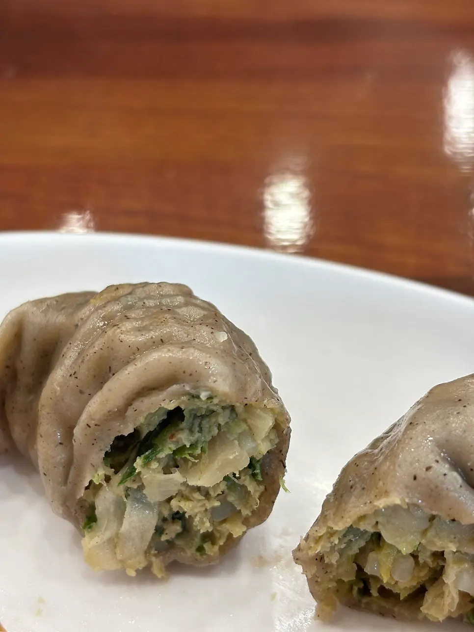 Buckwheat kimchi mandu dipped in seasoning sauce