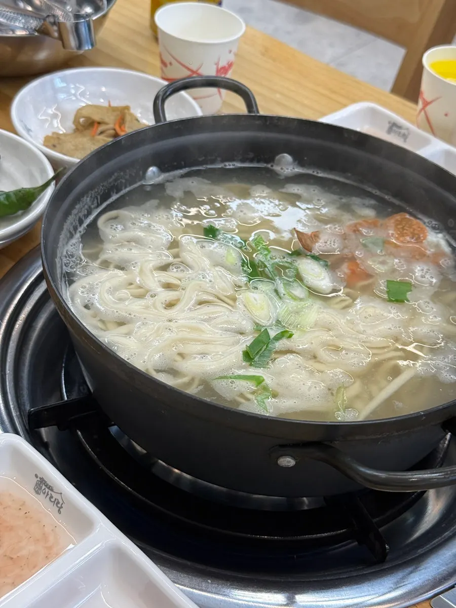 Full table of bossam and kalguksu, a hearty meal
