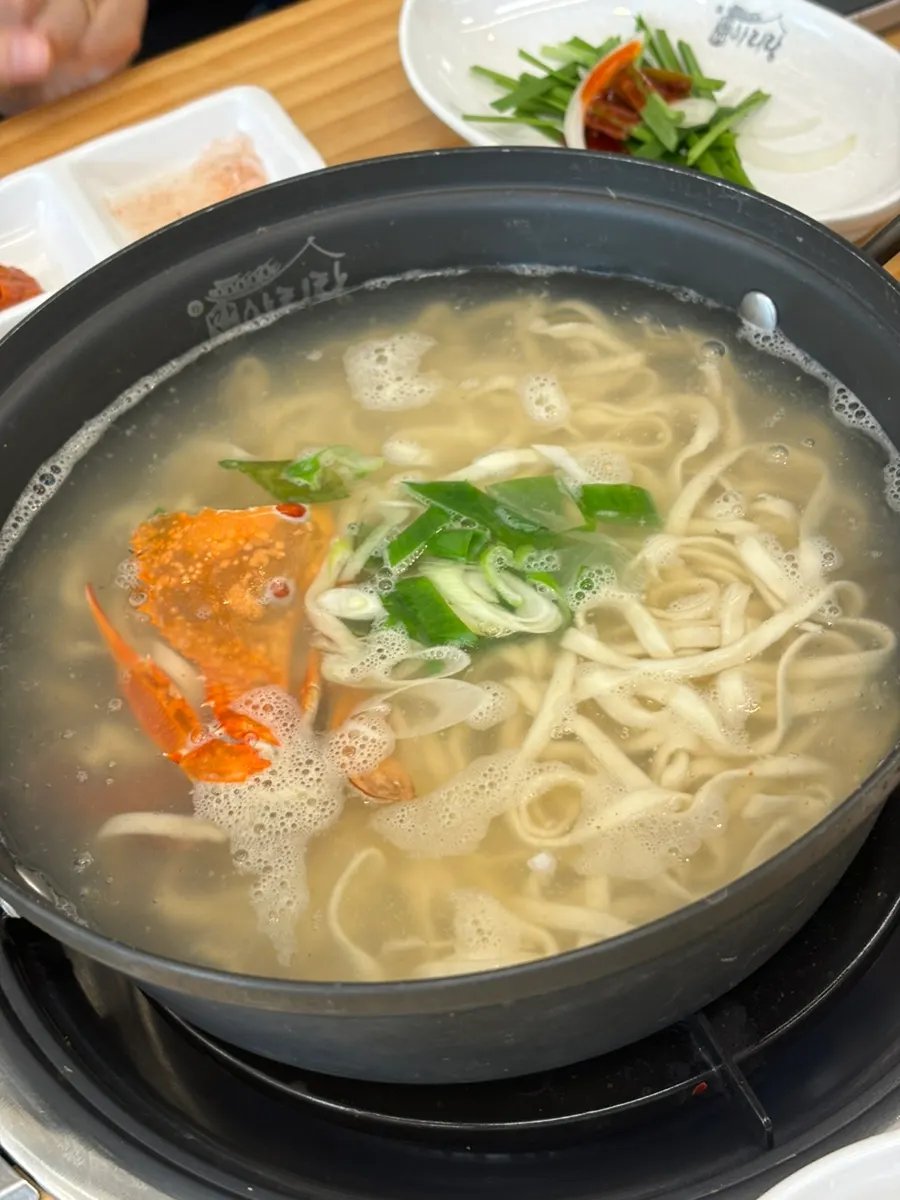 A wrap of cabbage with meat and kimchi inside
