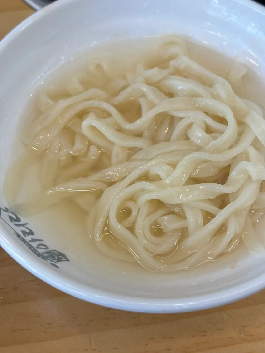 Clam kalguksu served alongside the bossam