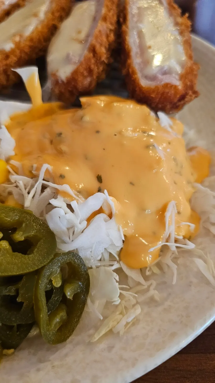 Cheese tonkatsu dipped in tonkatsu sauce