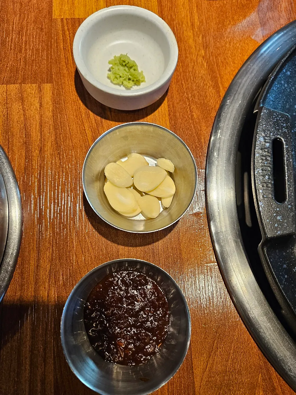 A spread of basic side dishes including seasoned crab and mustard leaf kimchi