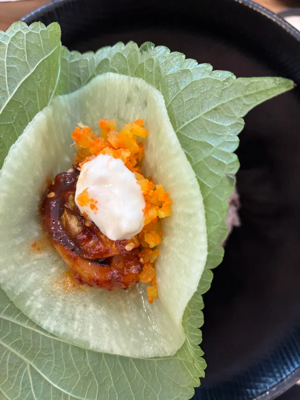 Jjukkumi wrapped with perilla leaves and pickled radish