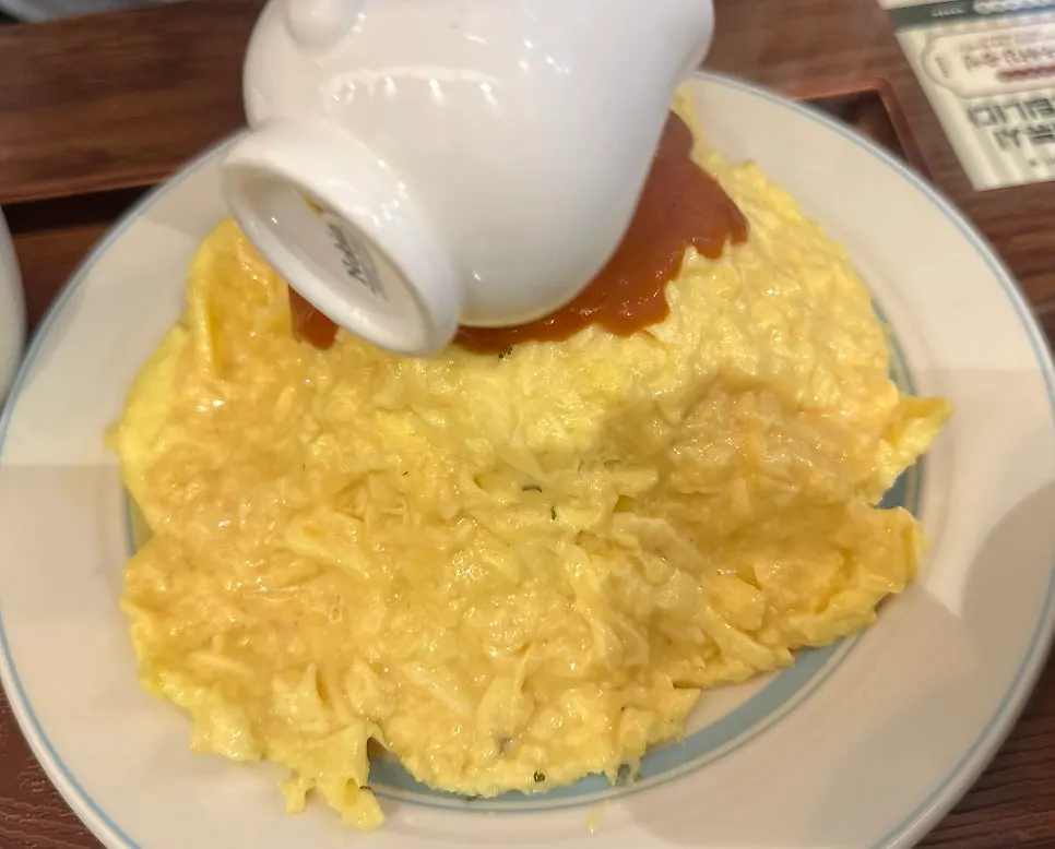A spoonful of omurice and fried rice