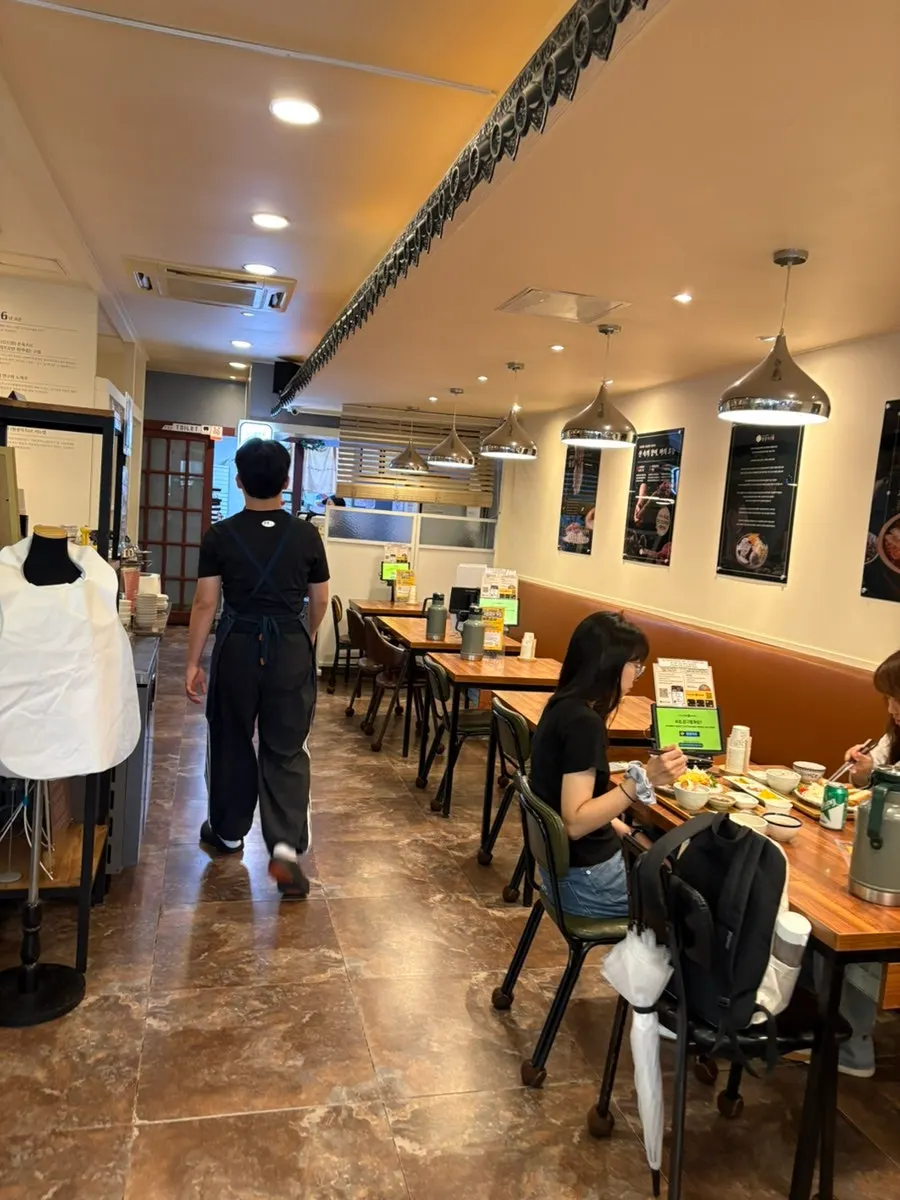 Interior of Wonkwang Katsu with tables lining both sides