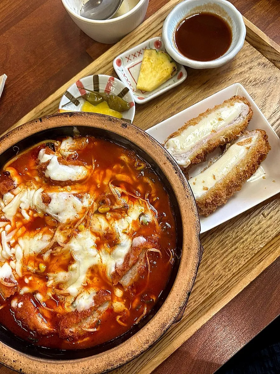 Table spread of spicy cheese-loaded pork cutlet