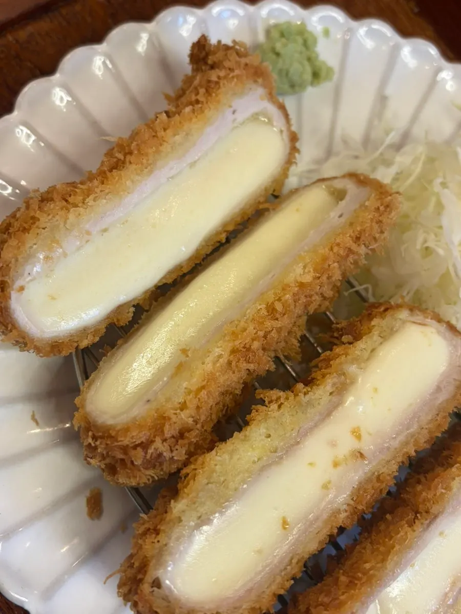Cross-section of Wonkwang cheese katsu showing cheese inside the crispy breading