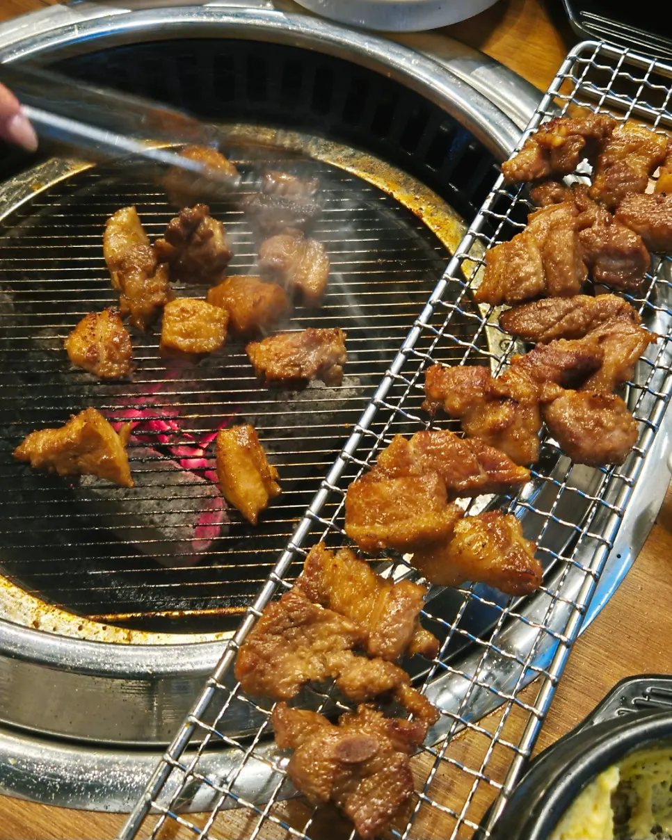 Seasoned pork galbi browning on the grill