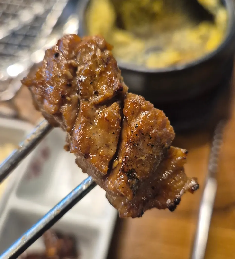 A grilled piece of pork galbi soaked in sauce