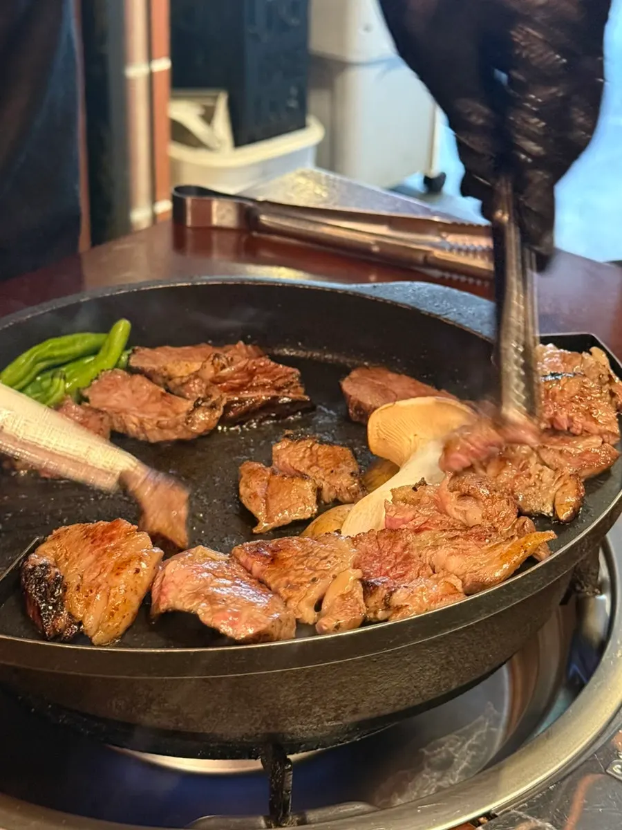 Staff grilling the aged galbi tableside