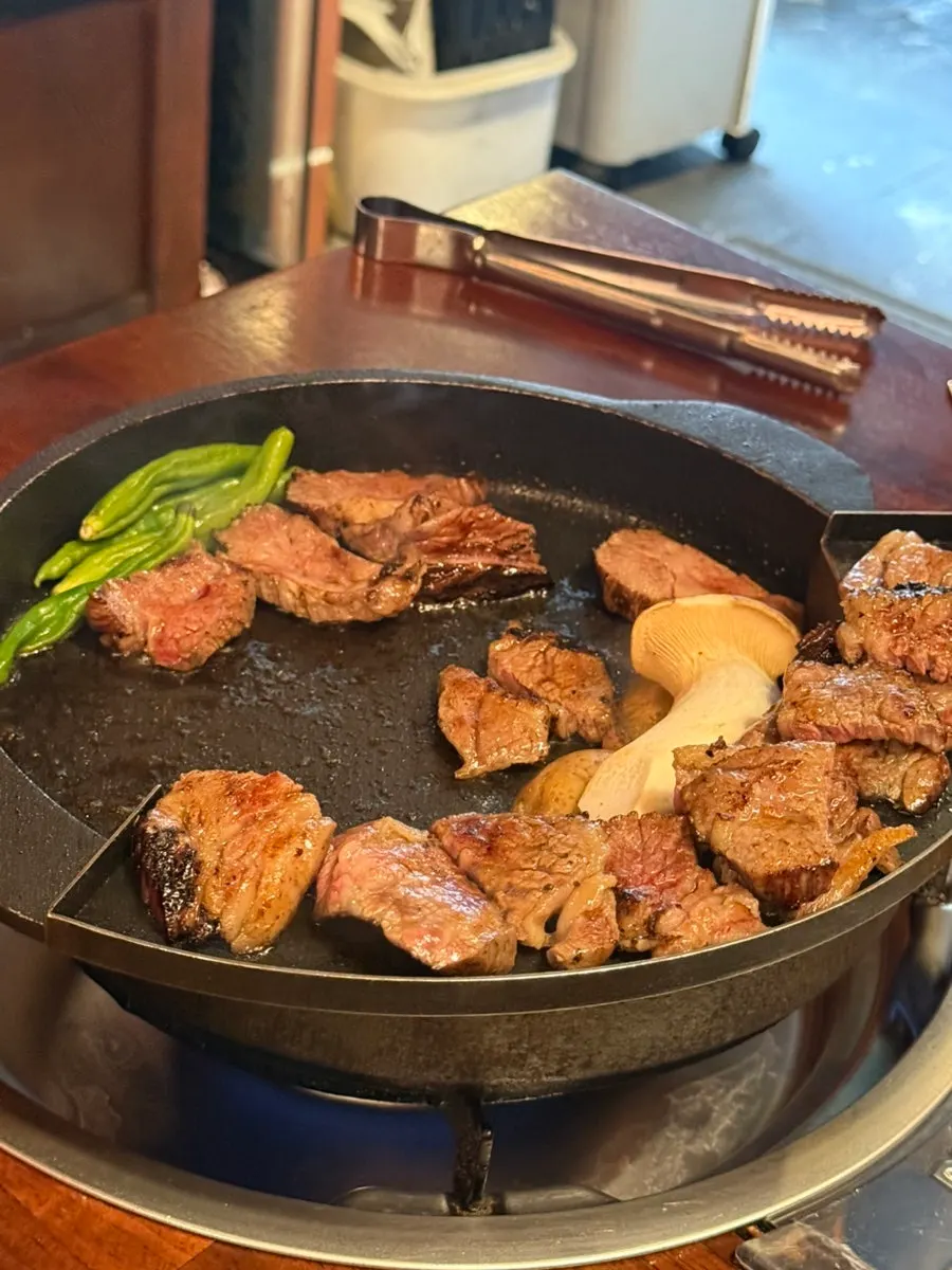 Grilled ribs set at the top of the grill