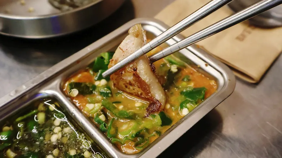 Final stage of the gopchang hot plate with side dishes