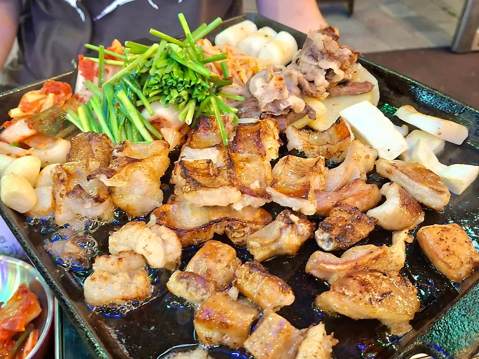 Staff member grilling each part of the gopchang platter