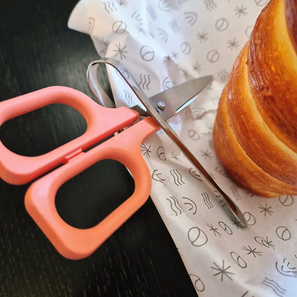 Table set with chimney bread, iced americano, and café latte