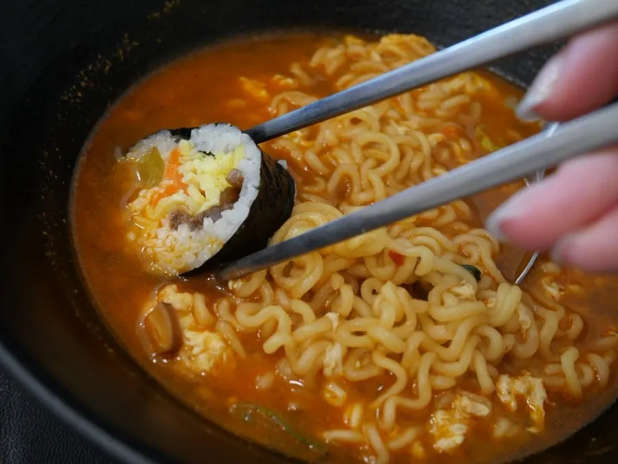 Bowl of ramen served with kimchi and radish pickle