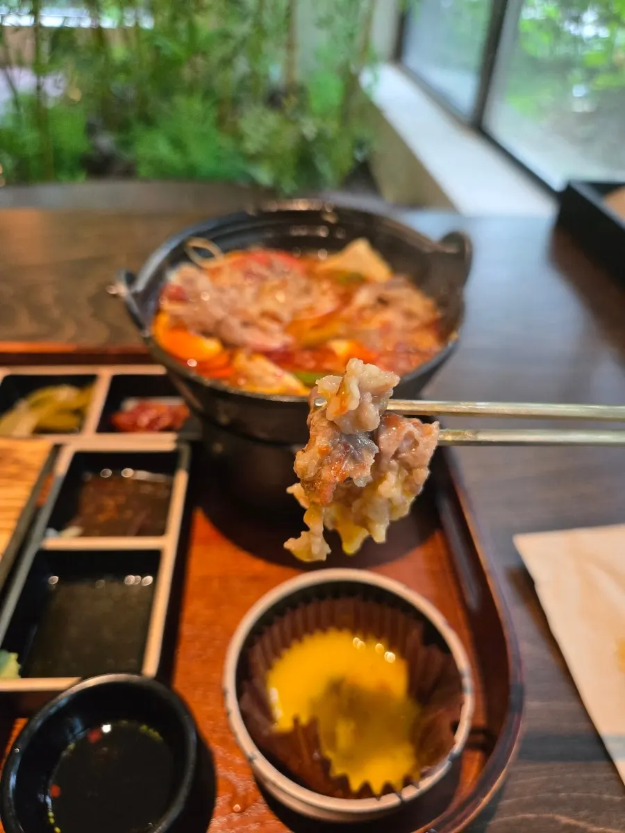 A bowl of hot stone rice with shiitake mushroom and bracken fern
