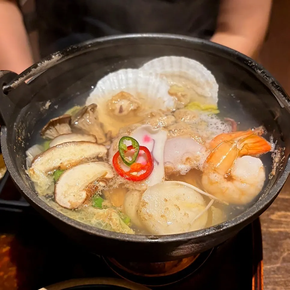Seafood hot pot with octopus, shrimp, scallops, and clams