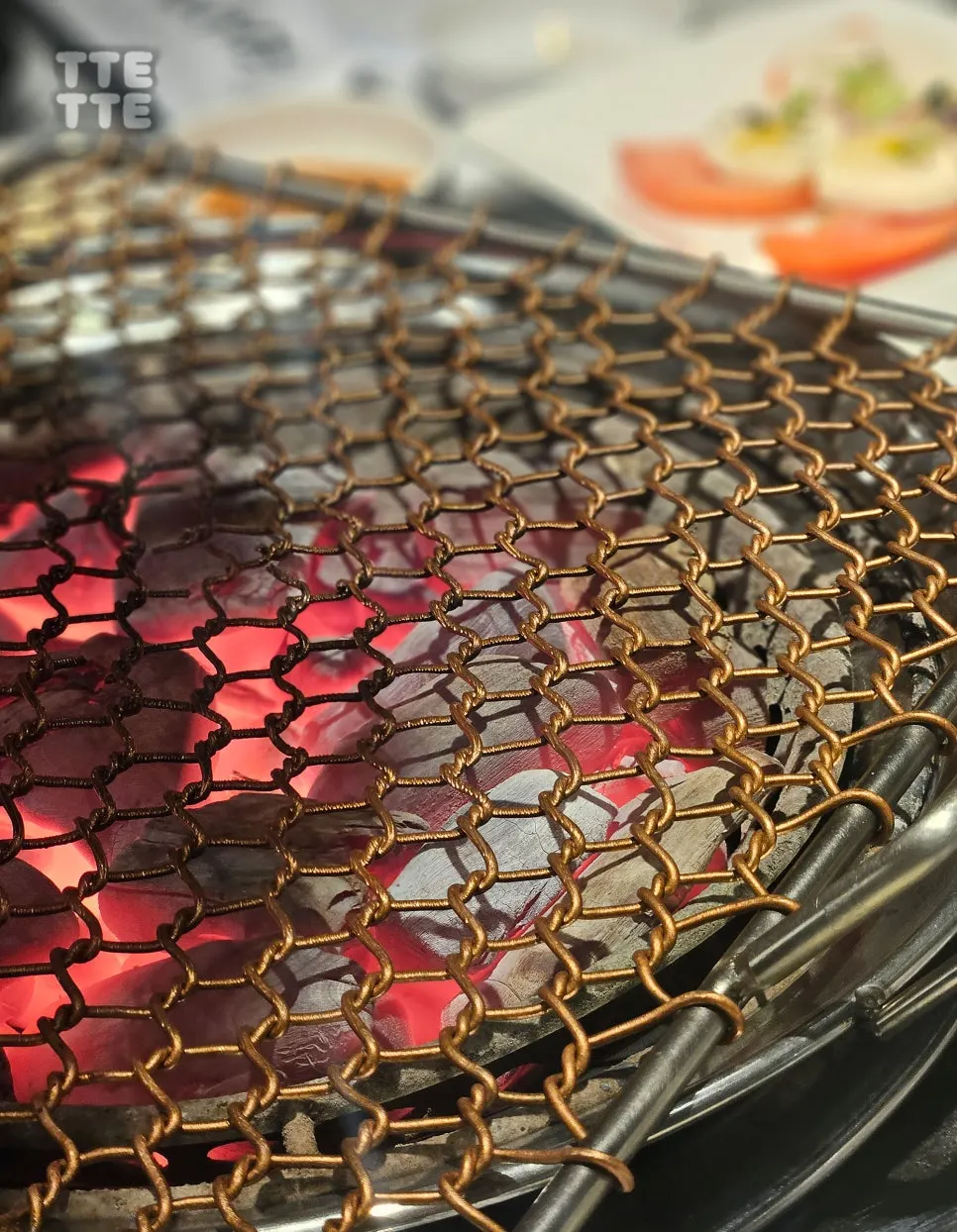 Charcoal fire glowing red in the grill