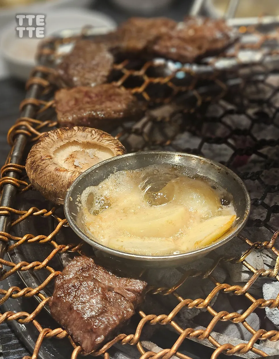 Hanwoo beef cooking on the charcoal grill plate
