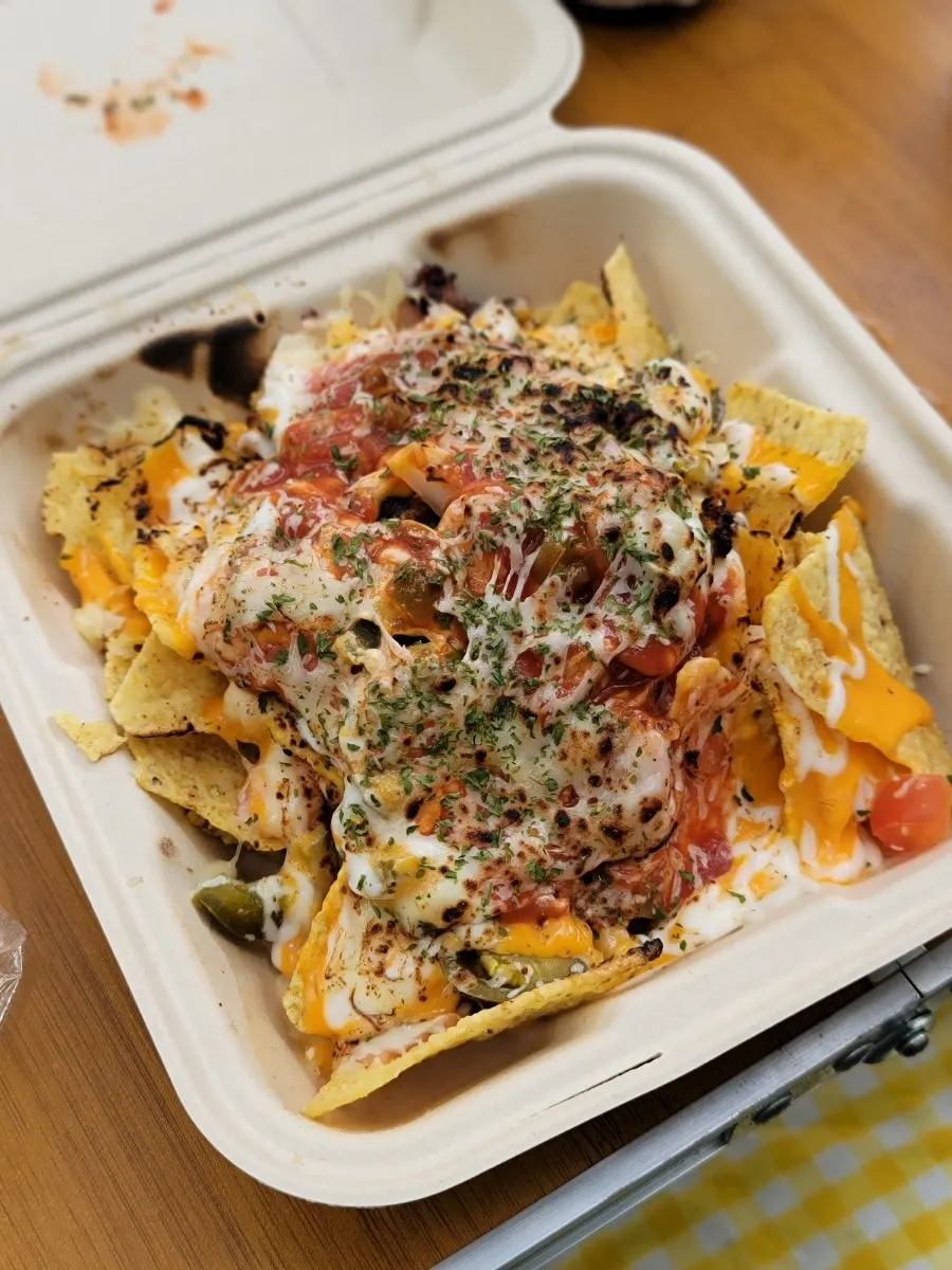 A bowl of nachos topped with beef brisket