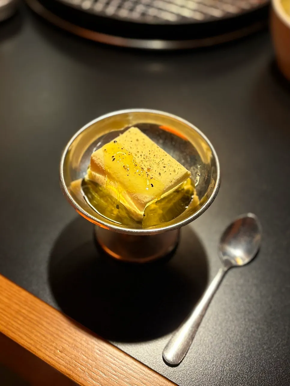 Dessert ice cream topped with pepper and olive oil