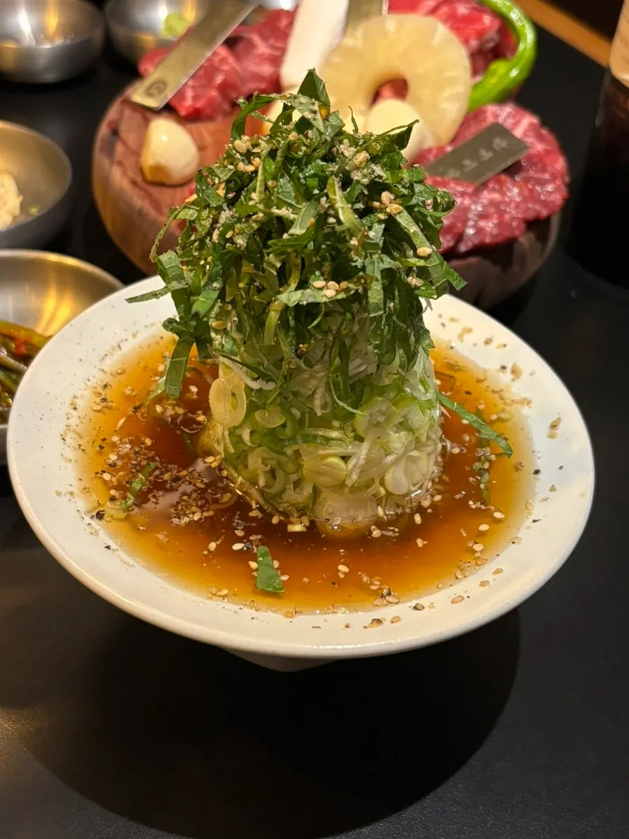 Green onion pile dipped in soy sauce